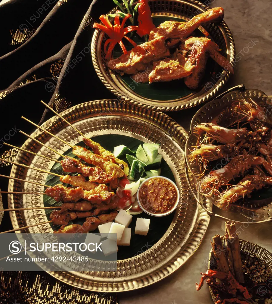 Indonesian food: satay with sticky rice, garlic prawns and friend chicken (ayam goreng)