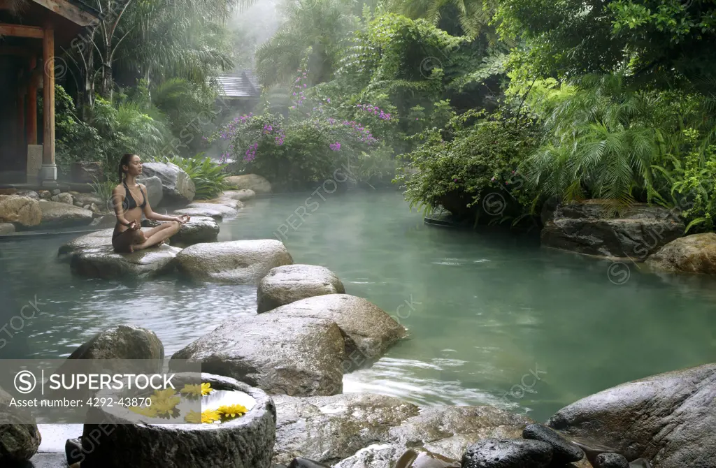 Hot Spring Pool at the Brilliant Resort & Spa in Kunming, Yunnan Province, China. Woman doing yoga
