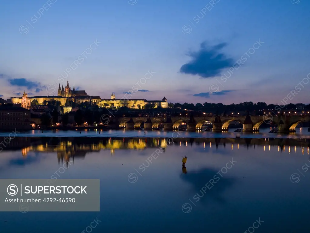 Czech Republic. Charles Bridge across the Vltava River illuminated at night with Hradcany Castle and St. Vitus Cathedral
