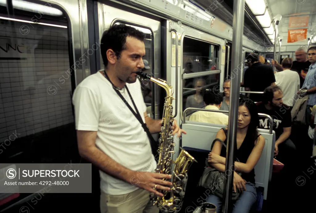 Man playing saxophone in metro, Paris, France
