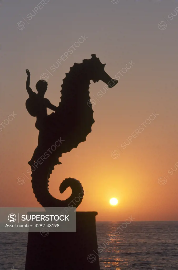 Mexico, Puerto Vallarta. Sea horse statue on Malecon at sunset