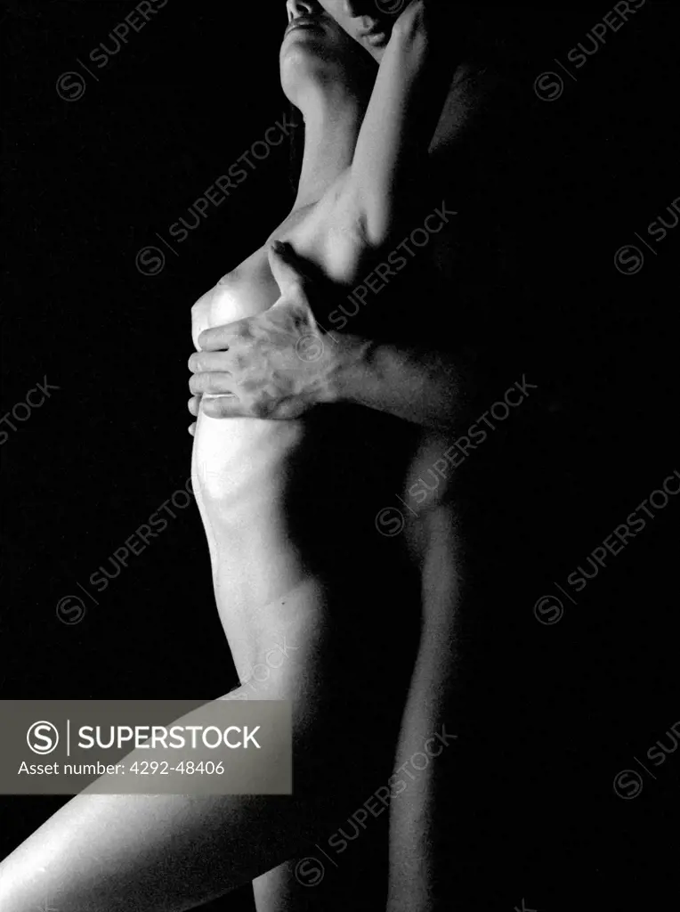 Naked man's and woman's body embracing