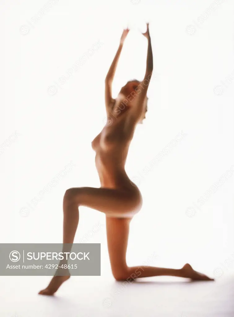 Silhouette of a naked woman dancing