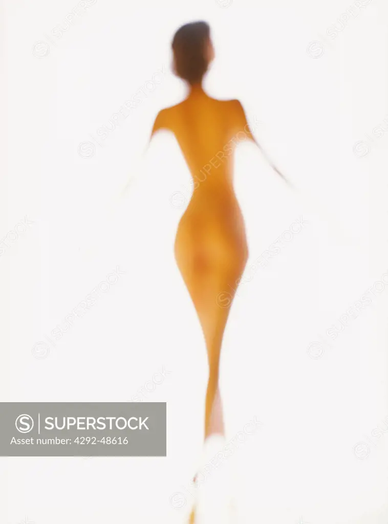 Silhouette of a naked woman dancing