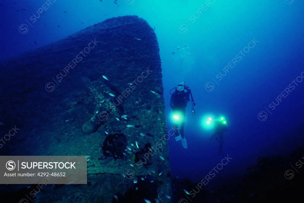 Italy, Lazio, Ventotene island, scuba divers exploring ship wreck