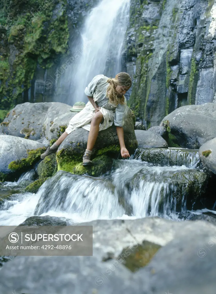 Africa, Kenya, Mount Kenya: woman by a waterfall