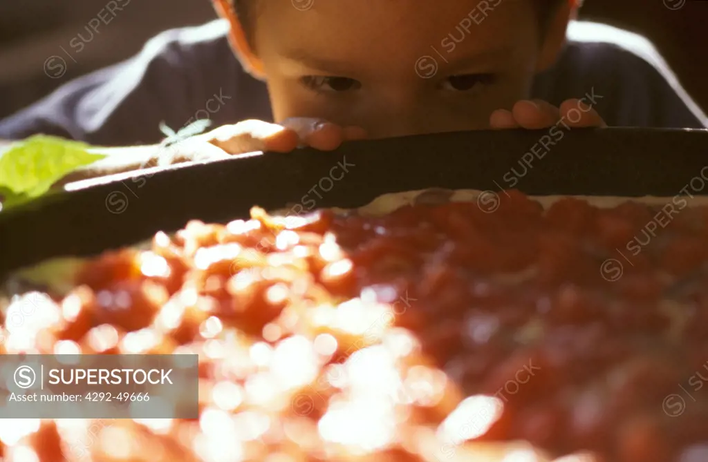 Child looking at pizza