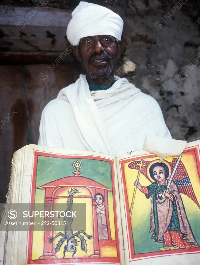 Ethiopia, Lake Tana, Monastery of Narga Selassie, man holding miniated missal