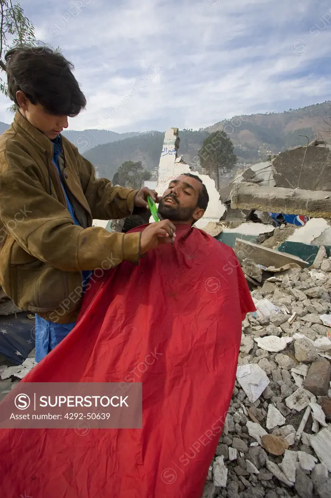Pakistan, Balakot. Man being shaved