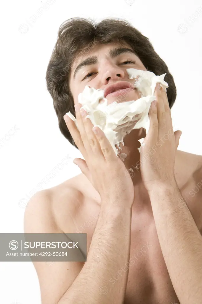 Young man applying shaving cream