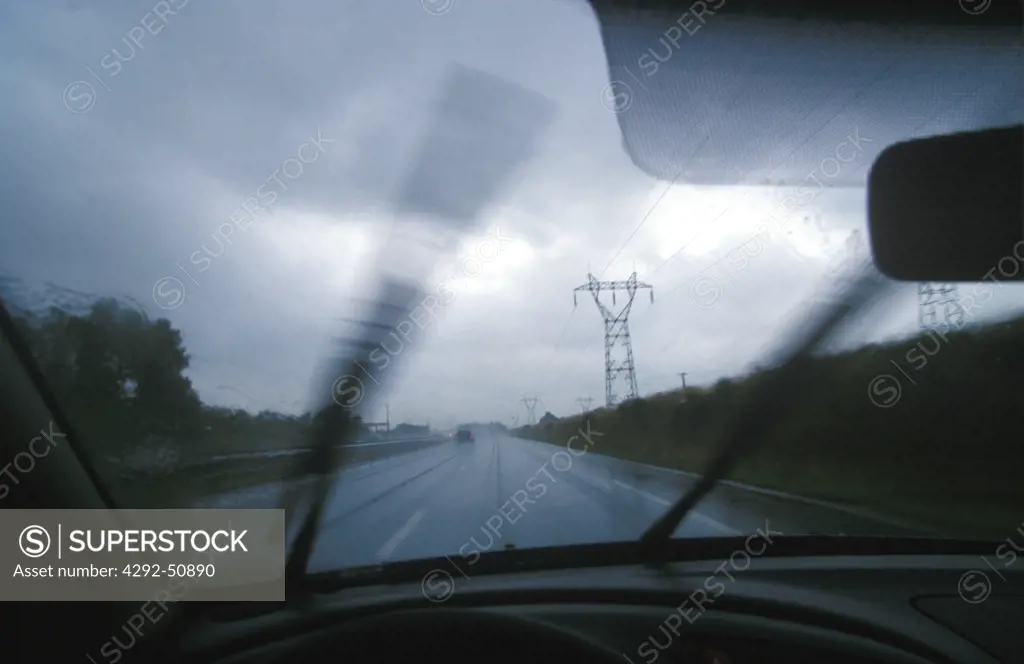 Driving in heavy rain, view through windshield