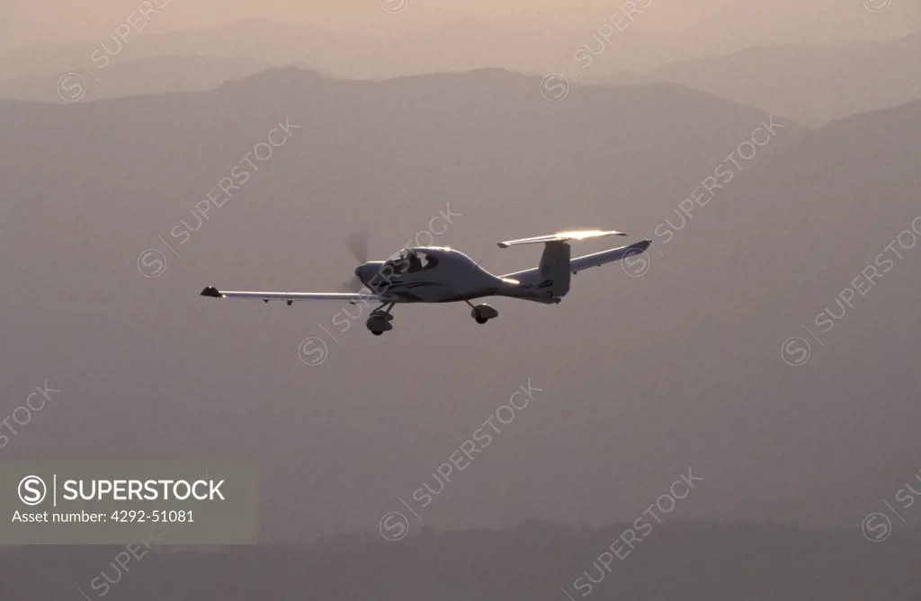 Light single-engine aircraft in flight (air-to-air shot), Diamondair DA40