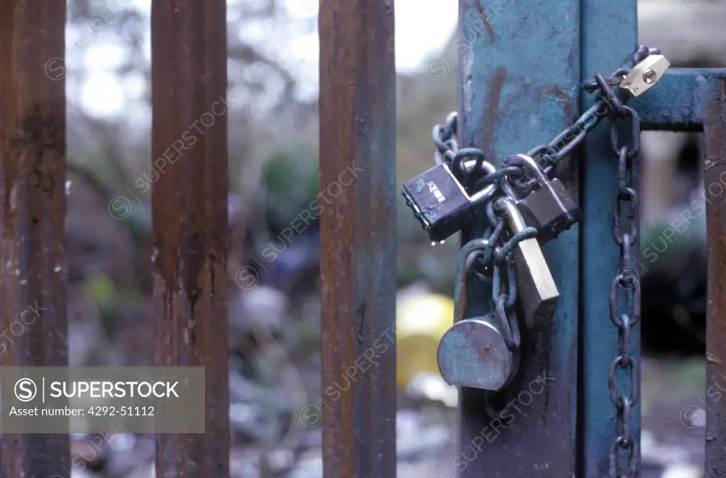 Padlocks and chain on rusty gate