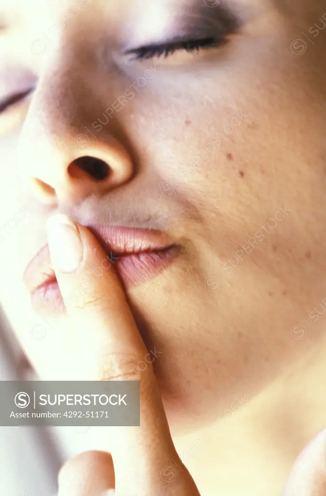 Woman with finger on the mouth