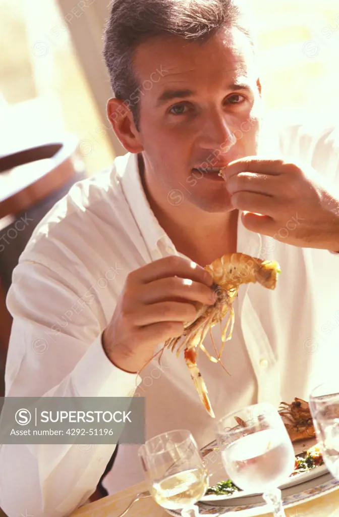 Man eating prawns