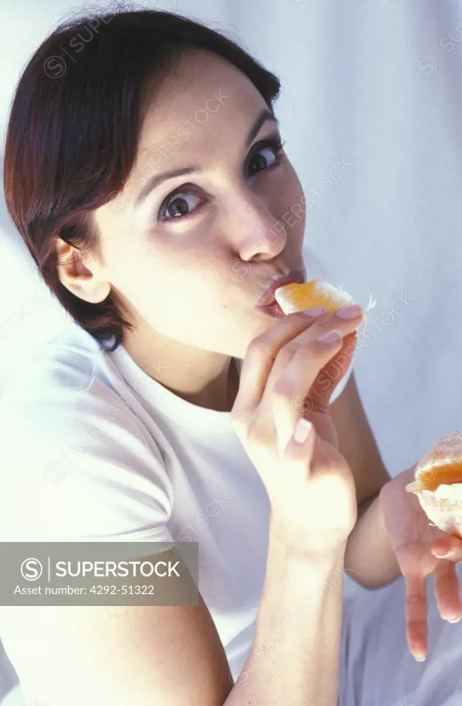 woman eating an orange
