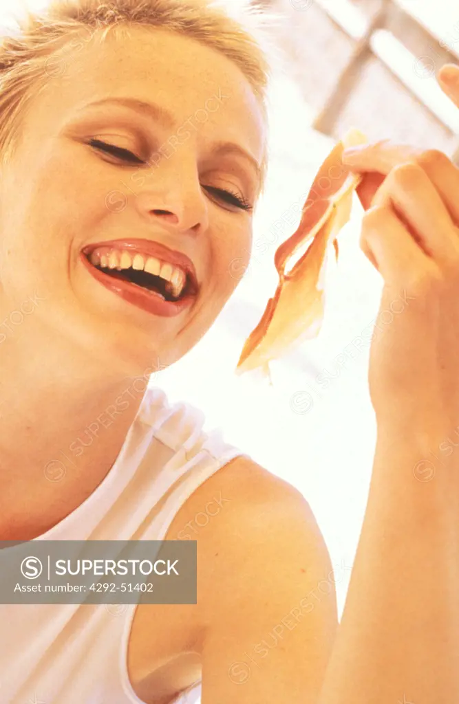 Woman eating ham