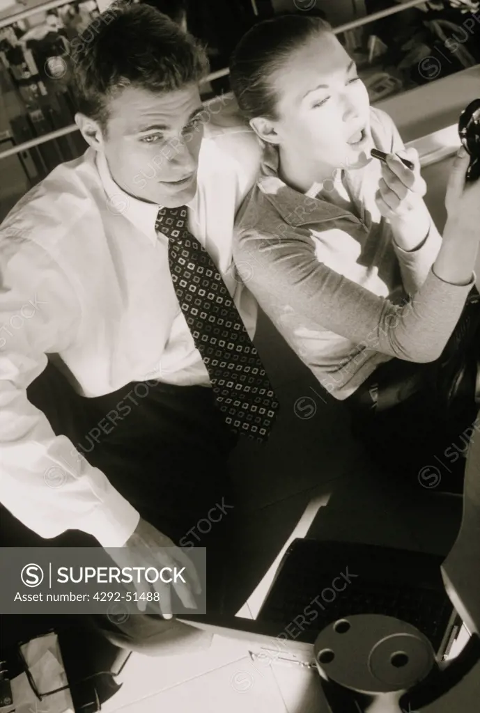 Businesswoman making up close to her partner