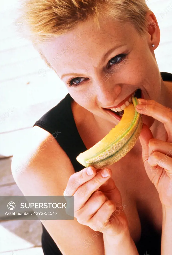Woman eating a slice of melon