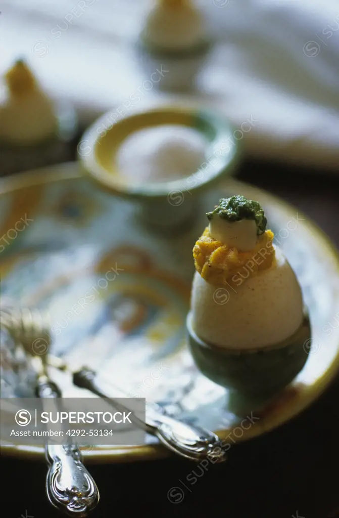 Stuffed egg with green sauce