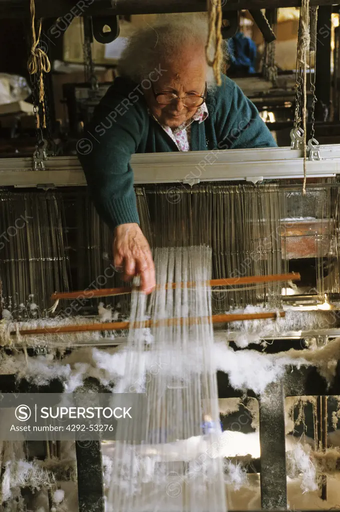 Italy, Liguria,Lorsica, woman working on loom