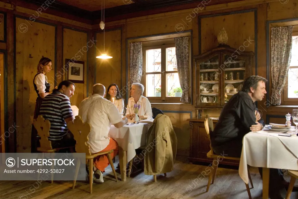 Italy, Trentino Alto Adige, Aldino, People having dinner in the old diningroom at Hotel