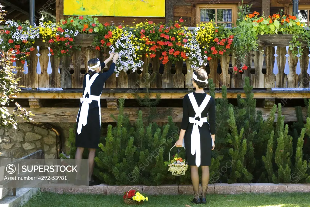 Two waitress picking up flowers