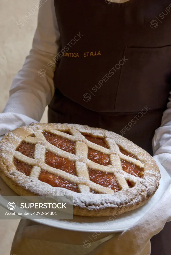 Waiter holding a pie