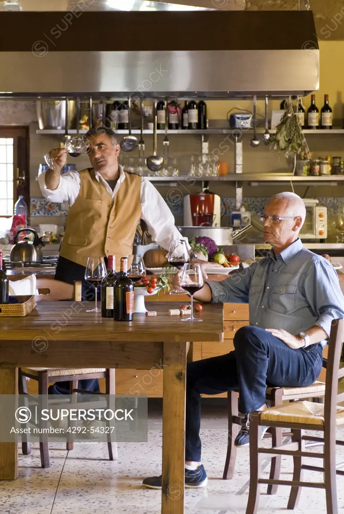 Italy, Sicily, Giambattista Cilia and Giusto Occhipinti tasting wine in the kitchen of Azienda Agricola Cos - Vittoria