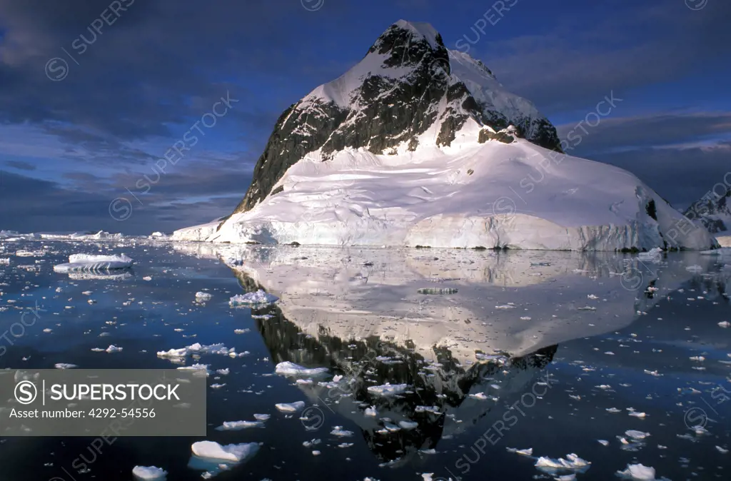 Antarctic Peninsula, Lemaine Canal. Iceberg and rocks