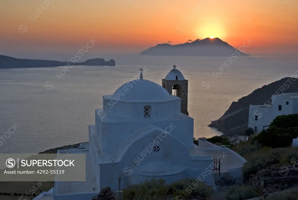Greece, Cyclades, Milos Island, Plaka village at sunset with the islands of Arkhati and Ormos Milou