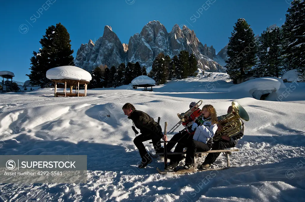 Italy, Trentino Alto Adige, Val di Funes, music band on sledge