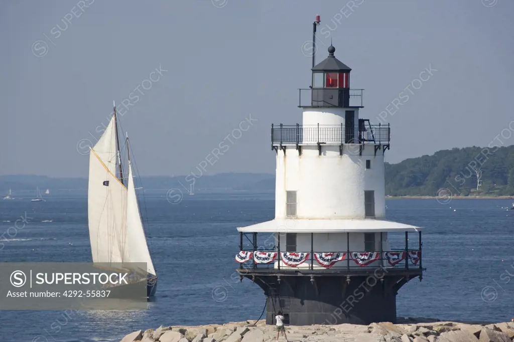 Schooner sailing toward the lighthouse at Spring Point. South Portland, Maine,USA