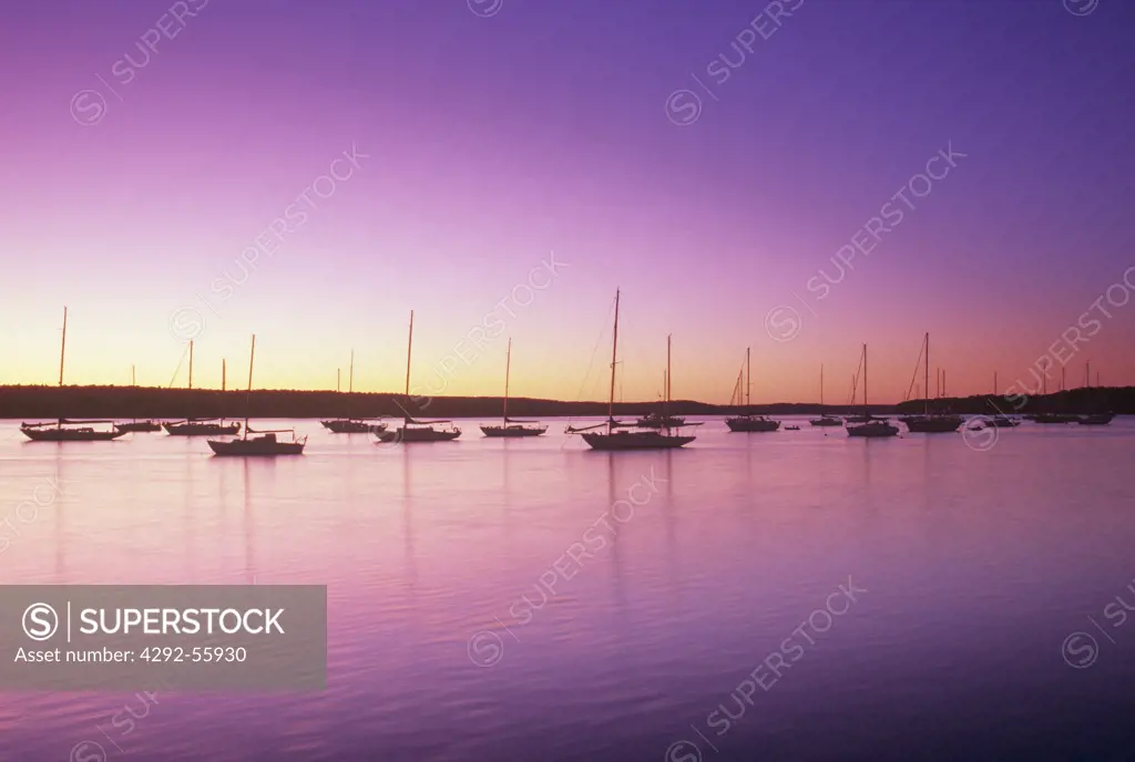 Boats moored in the Connecticut River at sunrise. Essex Connecticut,USA