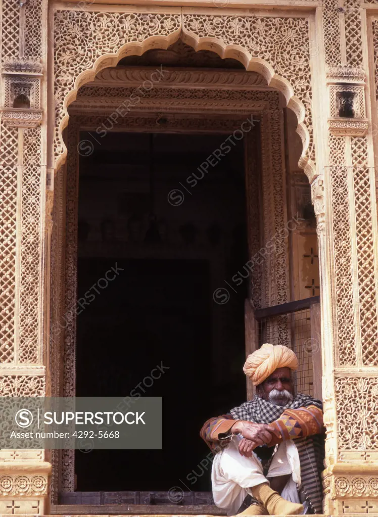 India, Jaisalmer, man sitting on door