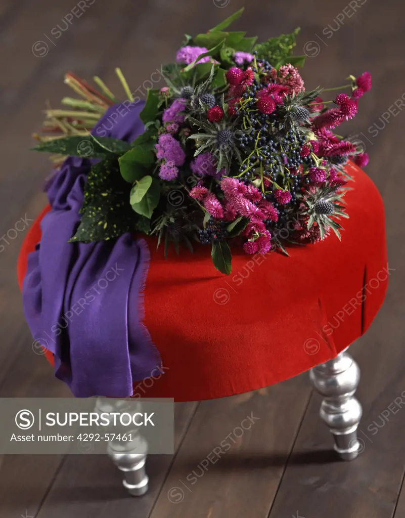 Bouquet on a red velvet pouf