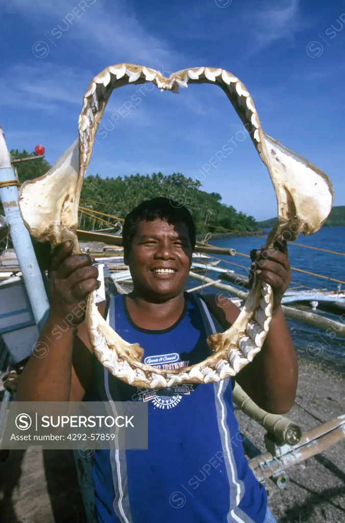 Philippines, fisherman holding shark jaw