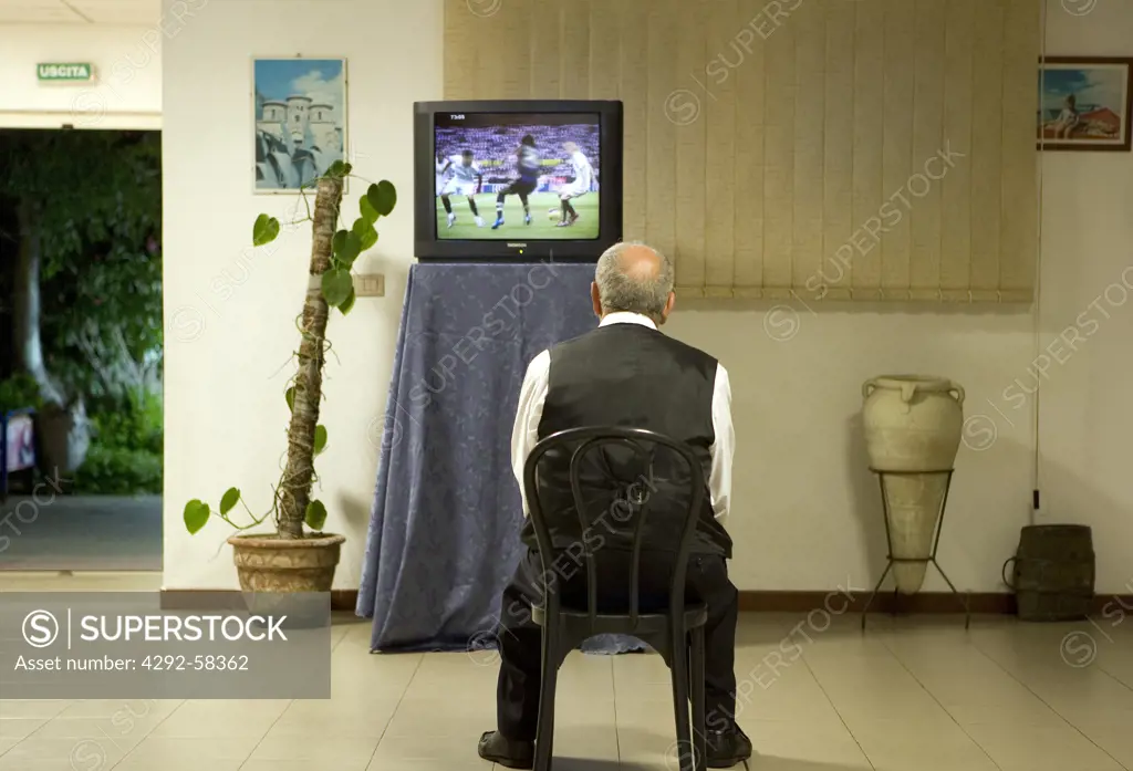 Senior man looking TV
