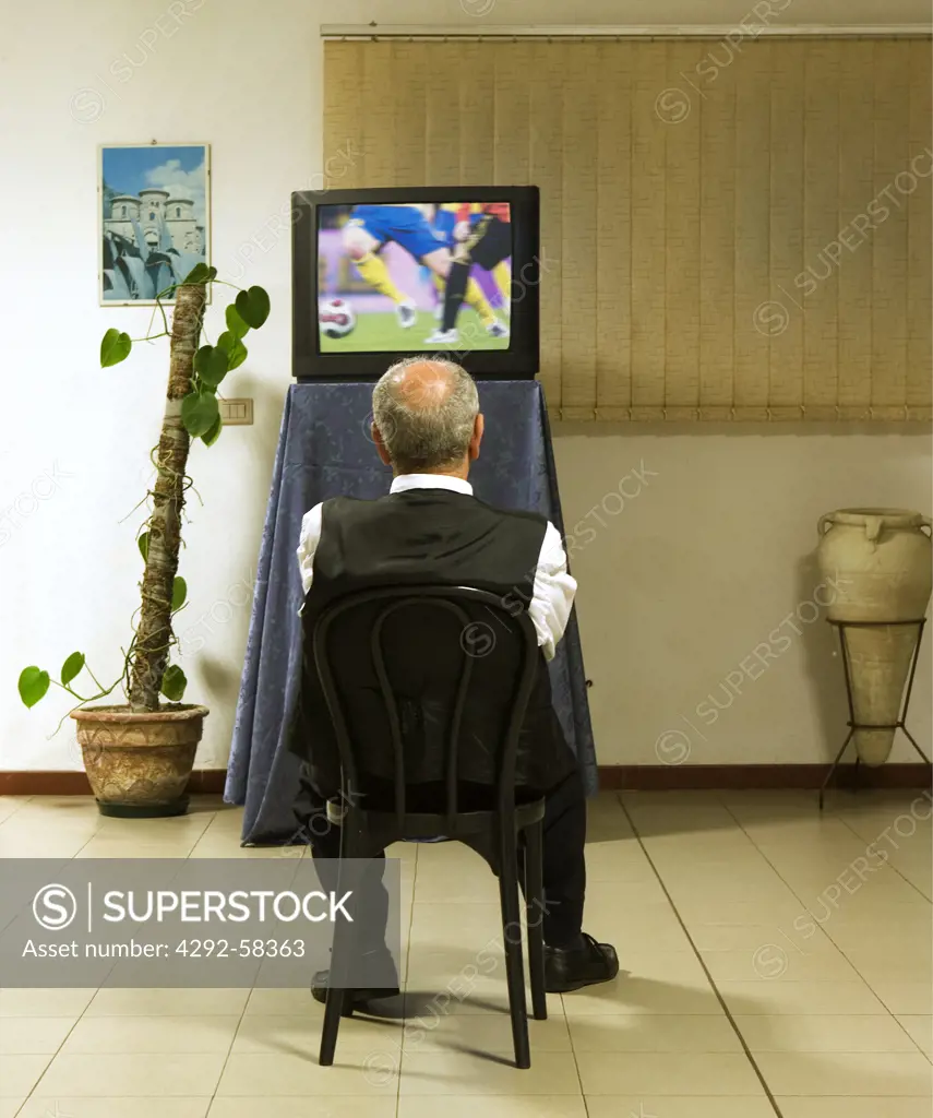Senior man looking TV