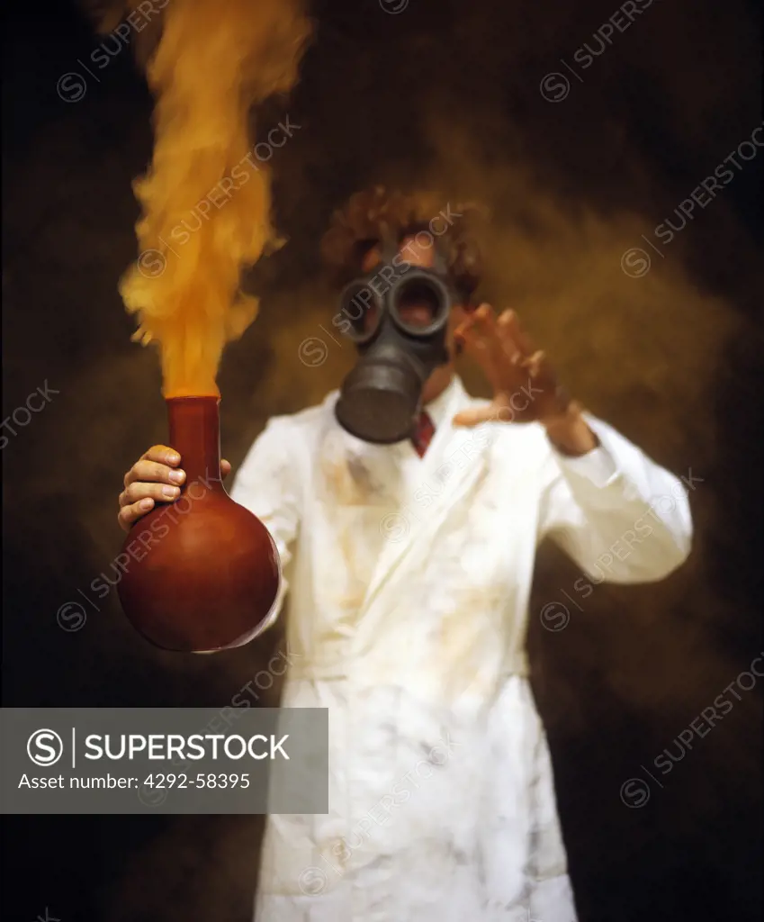 Man with gas mask and smoking laboratory flask