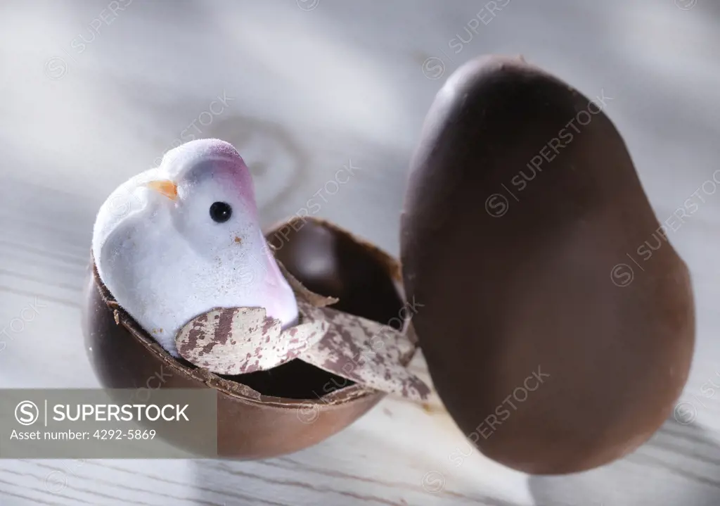 Easter chocolate egg with toy bird as surprise