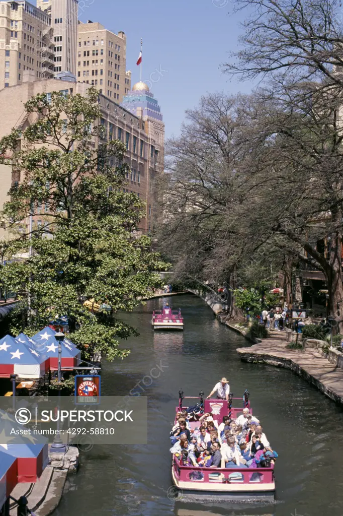 San Antonio River, San Antonio, Texas, USA: water taxi carries tourists through the heart of downtown San Antonio