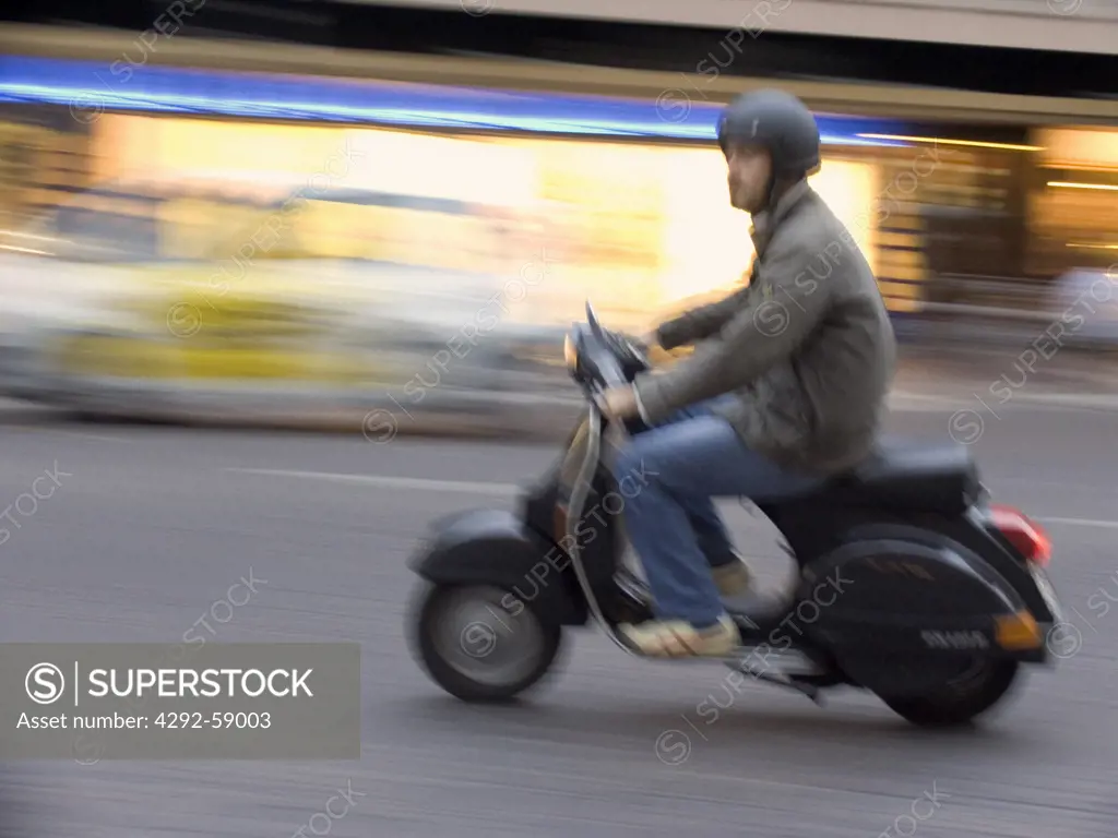 Man riding motorscooter