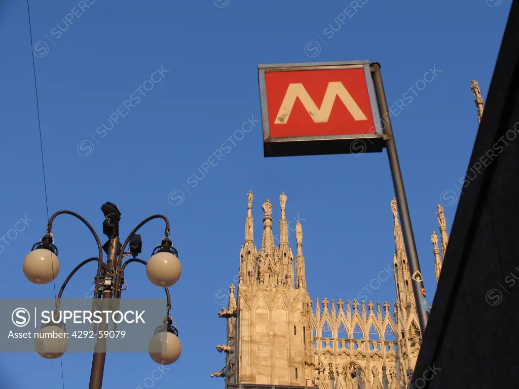 Italy, Lombardy, Milan, Metro entrance sign and the Duomo