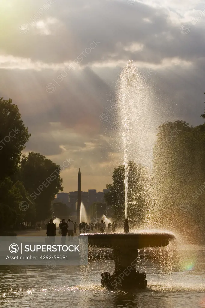 Fountain at Jardin des Tuileries sculpture garden with Place de la Concorde Obelisk, Paris France