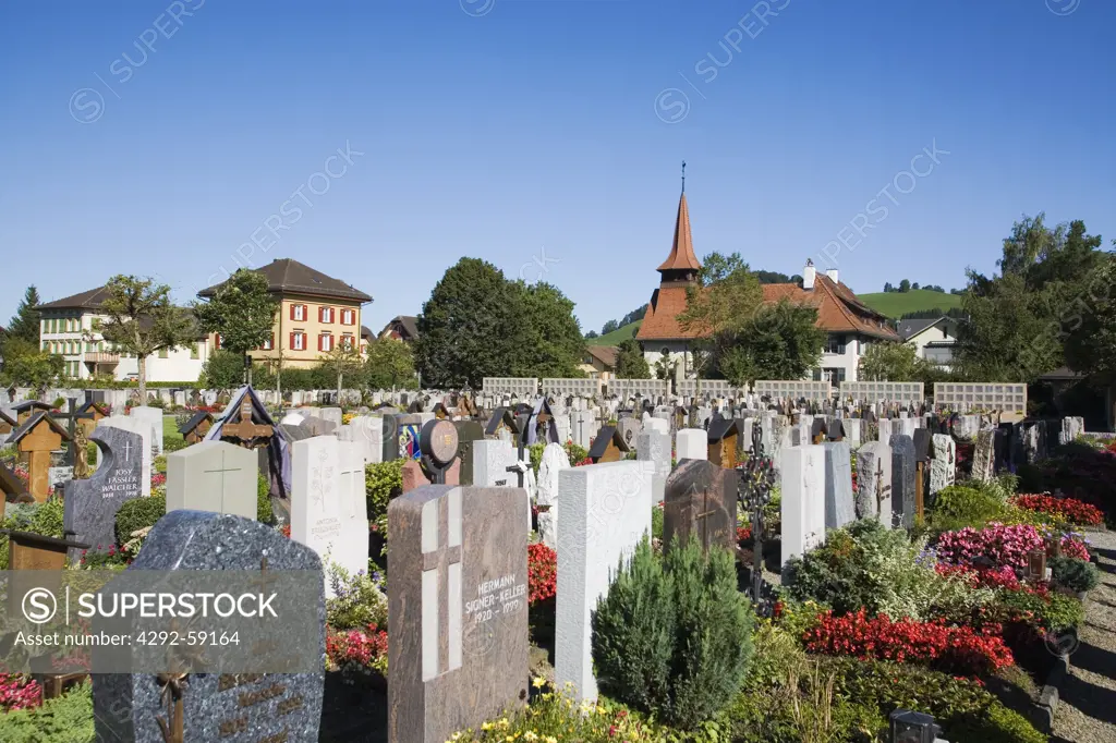 Switzerland, Appenzell, catholic church cemetery with the protestant evangelical church in background