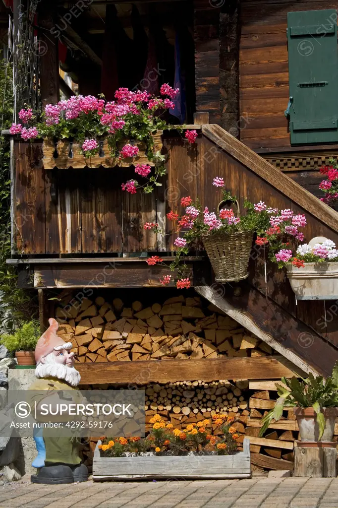 Switzerland, Gimmelwald. Garden gnome by staircase of a chalet