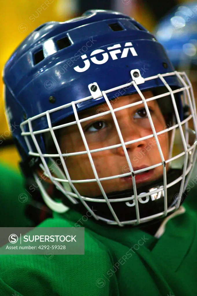 Boy with ice hockey helmet