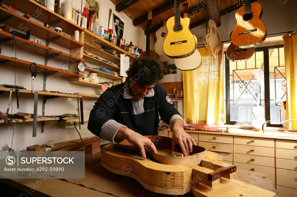 Craftsman making guitar