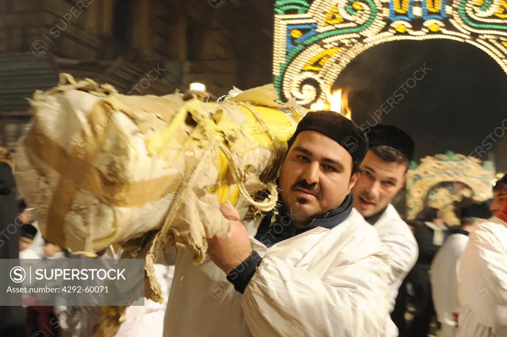 Italy, Sicily, Catania, man carrying candle during Sant'Agata Feast (the Patron Saint of the city)